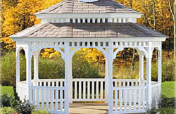 Oval Mini-Pagoda No14 white vinyl 2” x 2” balusters, black architectural asphalt shingles, gray composite flooring.